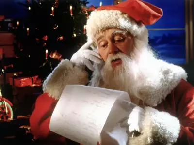 Santa claus is reading all letters from kids