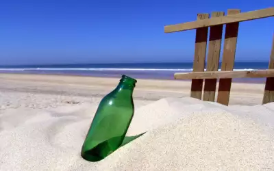 Forgotten bottle on sand Beach