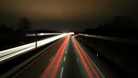 Nighttime Journey: Illuminated Highway Road in Captivating Darkness