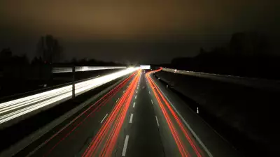 Highway road at night: A captivating image of illuminated lanes stretching into the darkness