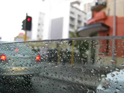 Rainy drive: A tranquil journey through a rain-spattered window in the car