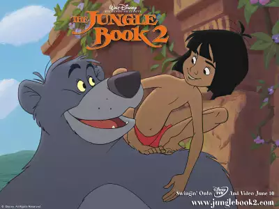 Mowgli smiling at Baloo as they reunite in The Jungle Book 2