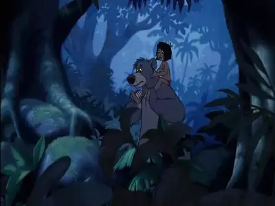 Mowgli sitting on Baloo's shoulders as they cautiously explore the jungle at night in The Jungle Book 2.