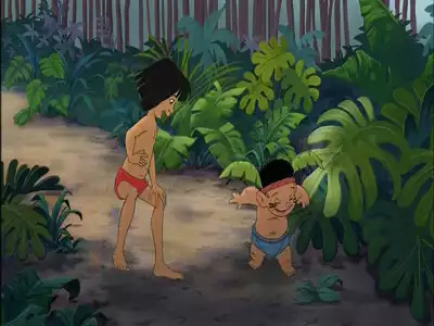 Mowgli and Ranjan playing and laughing in the jungle in a scene from The Jungle Book 2