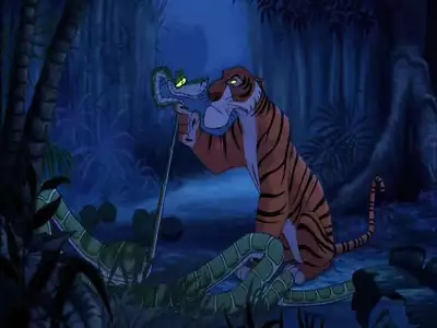 Shere Khan, the tiger, holds Kaa, the snake, in his paw in a tense moment in the jungle from The Jungle Book 2.