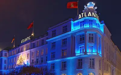 Hotel Atlantic exterior covered in snow, illuminated at night