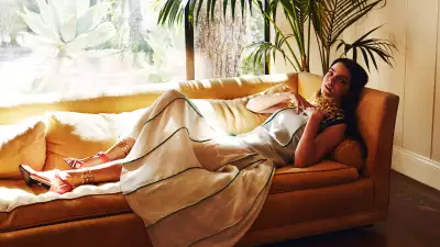 Anya Taylor-Joy laying on a couch showcasing relaxed elegance and glamour