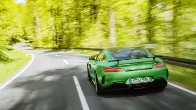 Green Mercedes AMG GT R showcasing its sculpted design and power from the back view