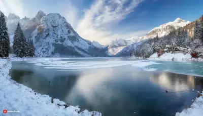 Winter Mountains with Beautiful Lake Wallpaper - Snow-covered peaks surrounding a serene lake in a breathtaking alpine landscape